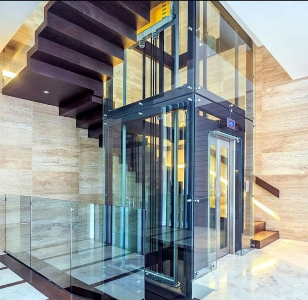 Glass elevator shaft beside a staircase